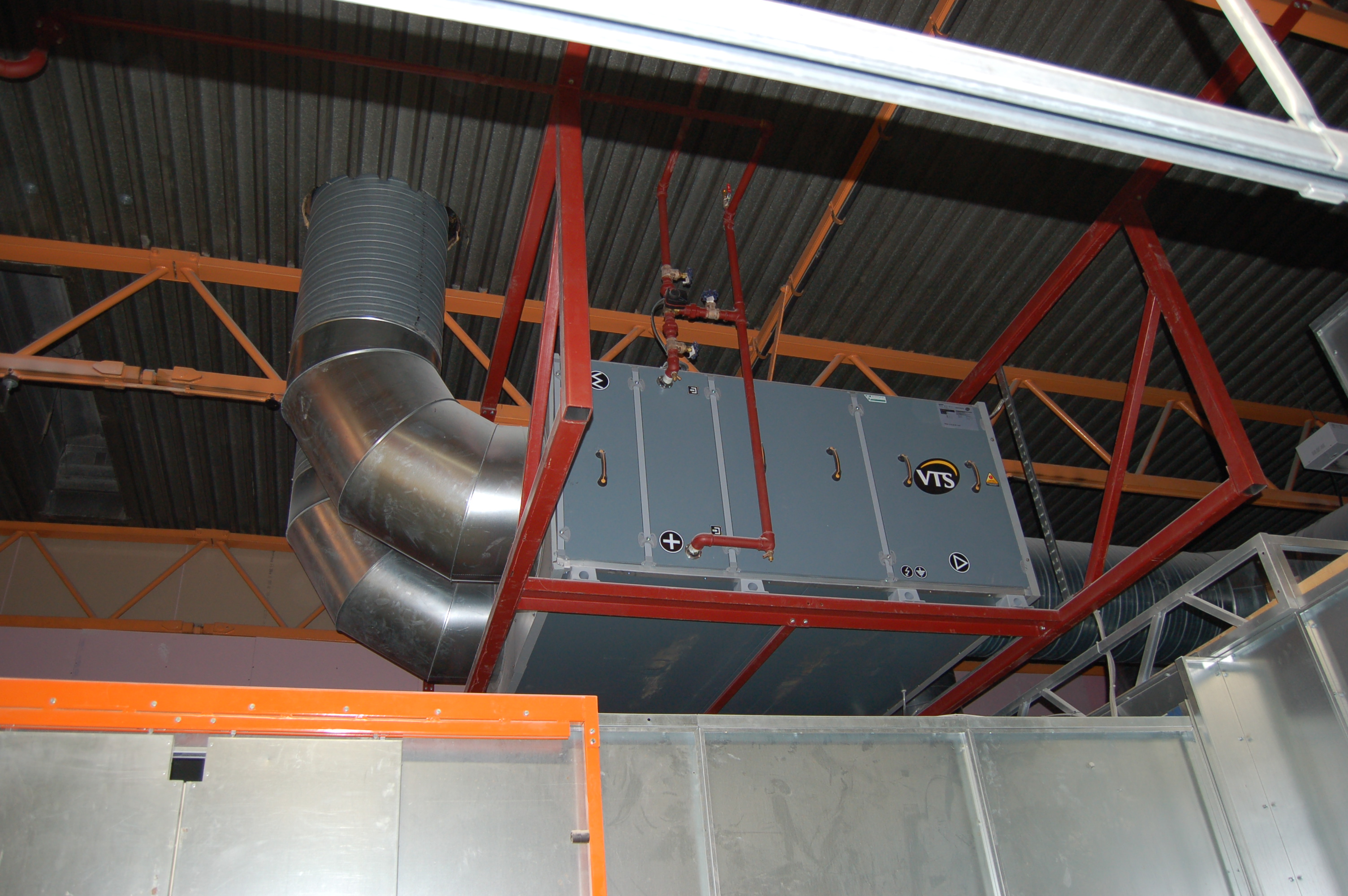 Air handling unit feeding heated make-up air into a paint line from outside.